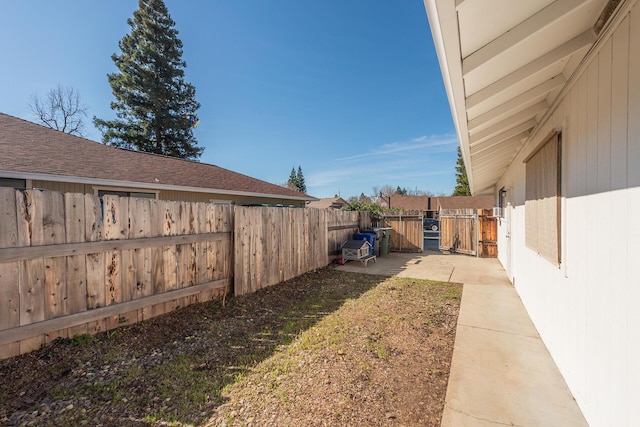 view of yard with a fenced backyard and a patio