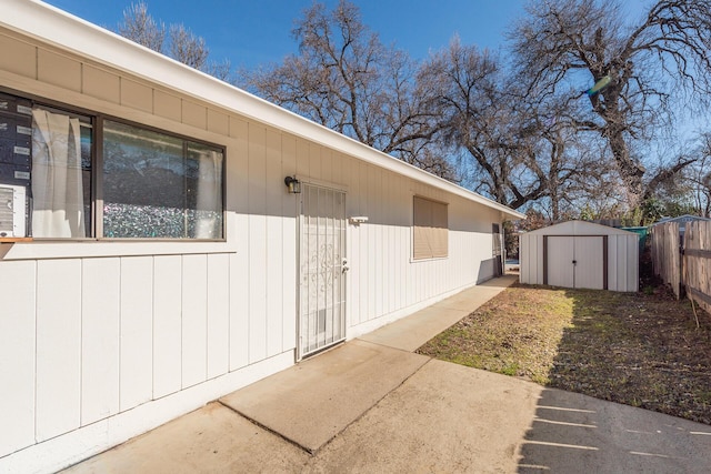 property entrance with fence and a patio