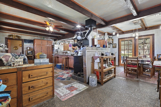 misc room with a ceiling fan and beam ceiling