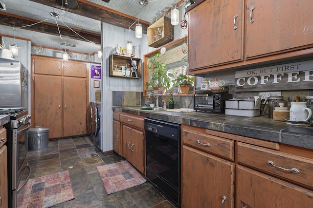 kitchen featuring a sink, appliances with stainless steel finishes, independent washer and dryer, brown cabinetry, and stone finish floor