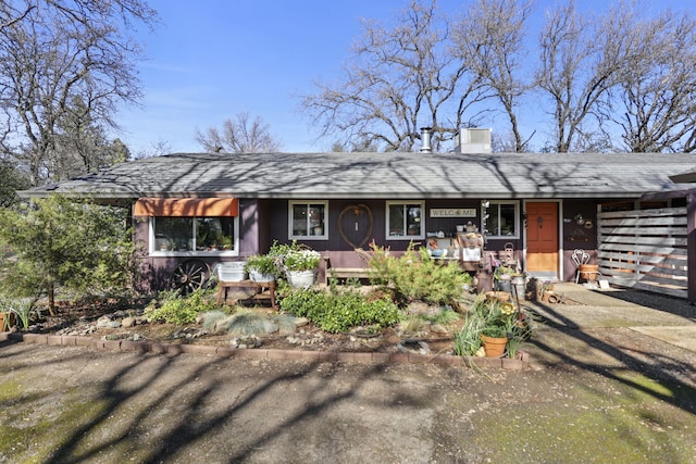 single story home featuring covered porch and a chimney