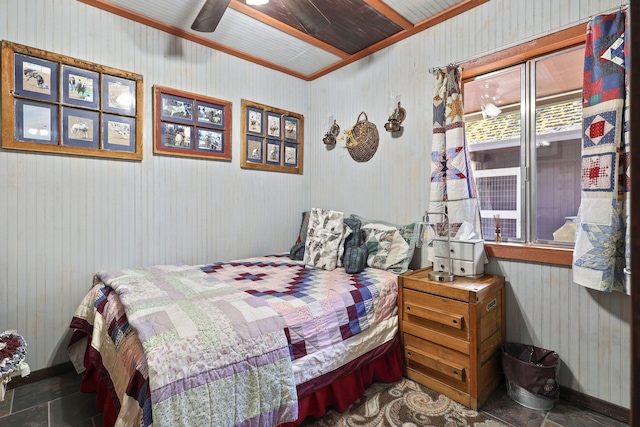 bedroom featuring stone finish flooring, ceiling fan, and baseboards