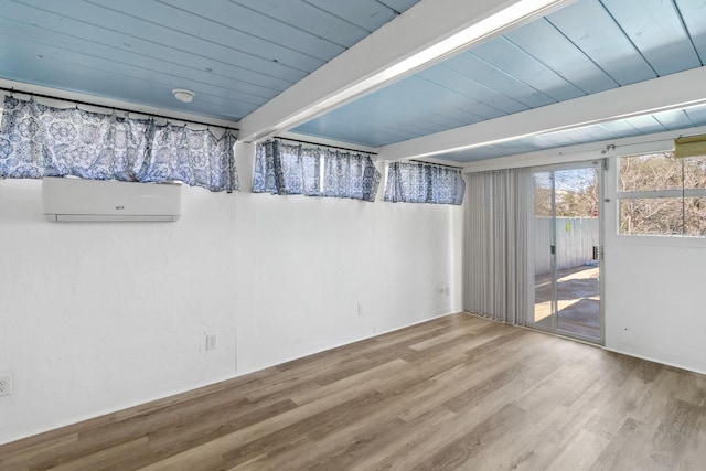 unfurnished room with wooden ceiling, wood finished floors, beamed ceiling, and a wall mounted AC