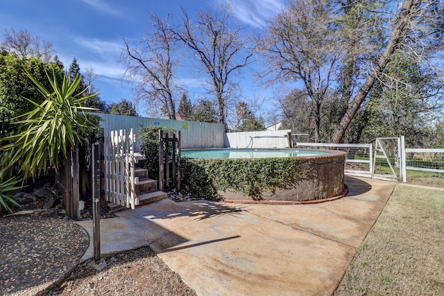 view of patio / terrace featuring a gate, fence, and a pool