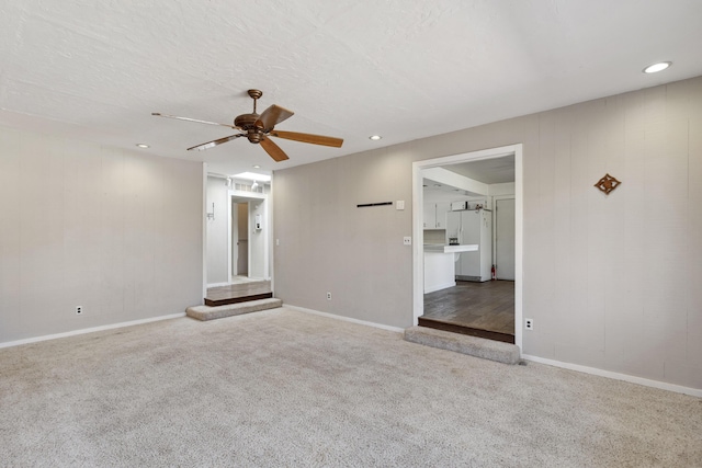 carpeted empty room featuring a ceiling fan, recessed lighting, a textured ceiling, and baseboards