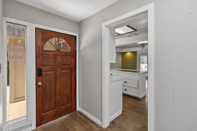 entryway featuring dark wood-style flooring and visible vents