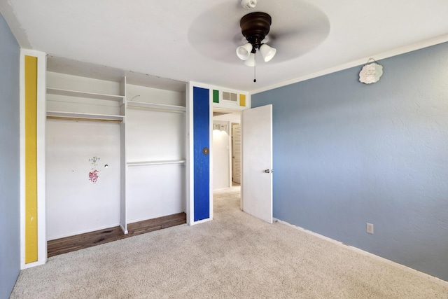 unfurnished bedroom featuring ceiling fan, carpet flooring, visible vents, baseboards, and a closet