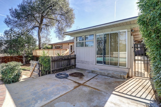 view of patio featuring fence and a wooden deck