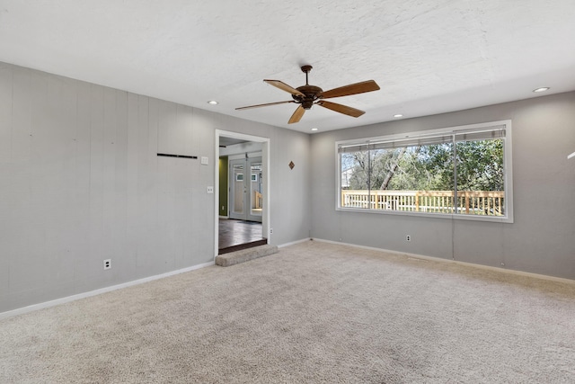 carpeted empty room with recessed lighting, ceiling fan, a textured ceiling, and baseboards