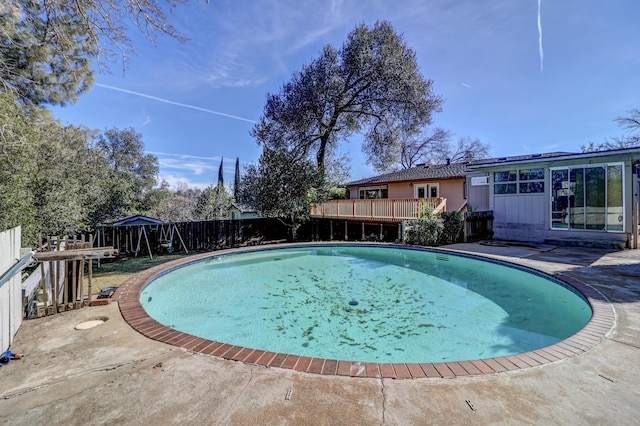 view of swimming pool featuring a fenced in pool, a patio area, fence, and a wooden deck