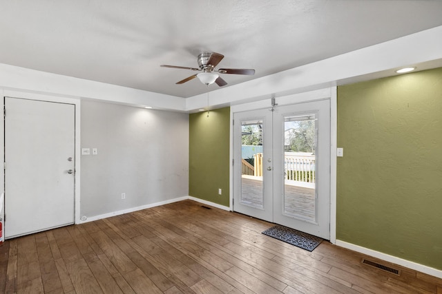 interior space featuring visible vents, baseboards, and hardwood / wood-style flooring