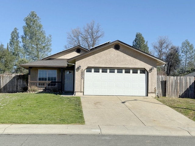 ranch-style home featuring a garage, driveway, fence, a front lawn, and stucco siding