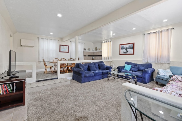 living area featuring beamed ceiling, an AC wall unit, a textured ceiling, recessed lighting, and baseboards