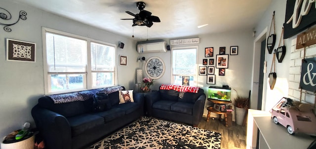 living area with an AC wall unit, wood finished floors, and a ceiling fan