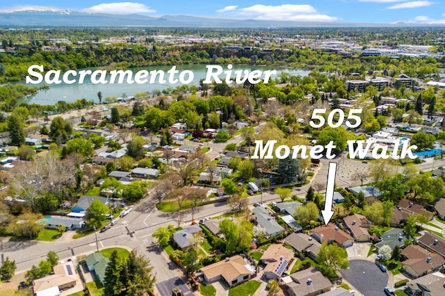 drone / aerial view featuring a residential view and a water and mountain view