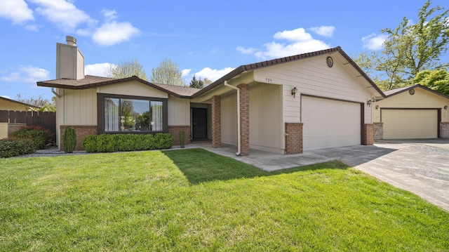 view of front of home with a front lawn, brick siding, an attached garage, a chimney, and concrete driveway