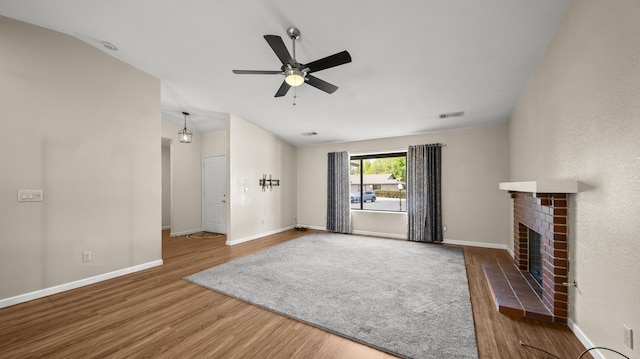 unfurnished living room with wood finished floors, ceiling fan, baseboards, and visible vents