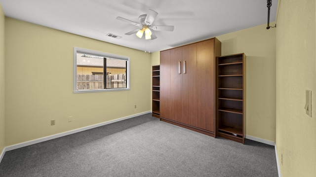 unfurnished bedroom featuring visible vents, baseboards, a ceiling fan, and carpet floors