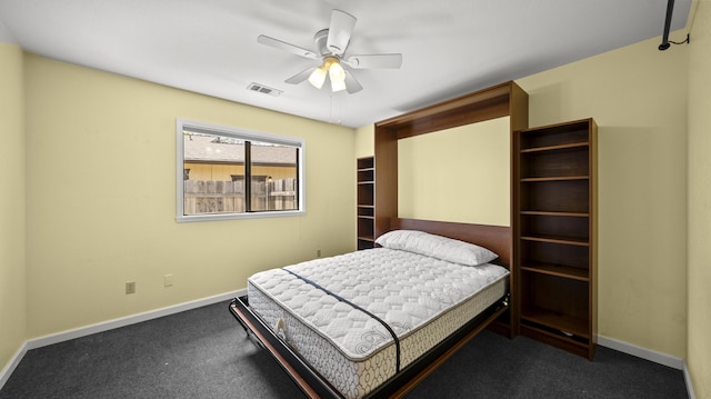 carpeted bedroom with baseboards, a ceiling fan, and visible vents