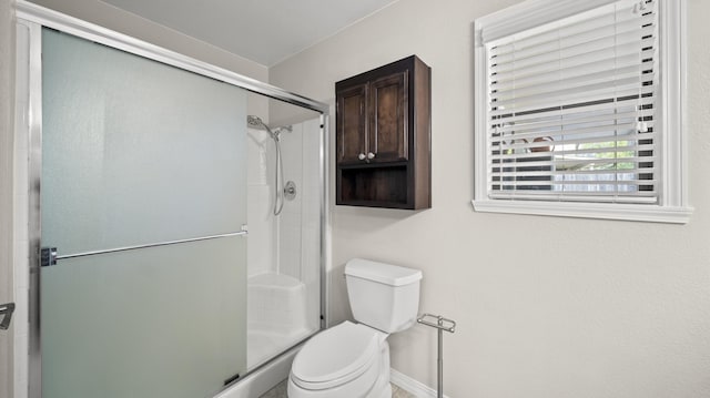 full bath with toilet and a shower stall