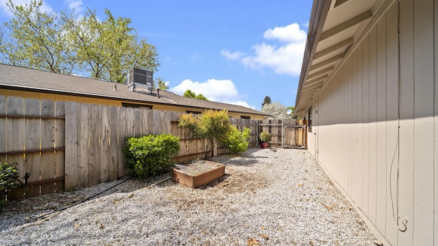 view of yard featuring central AC unit and a fenced backyard