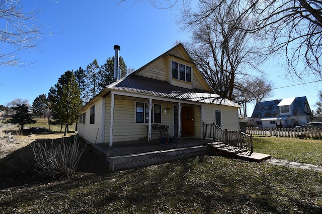 view of front facade featuring covered porch and metal roof