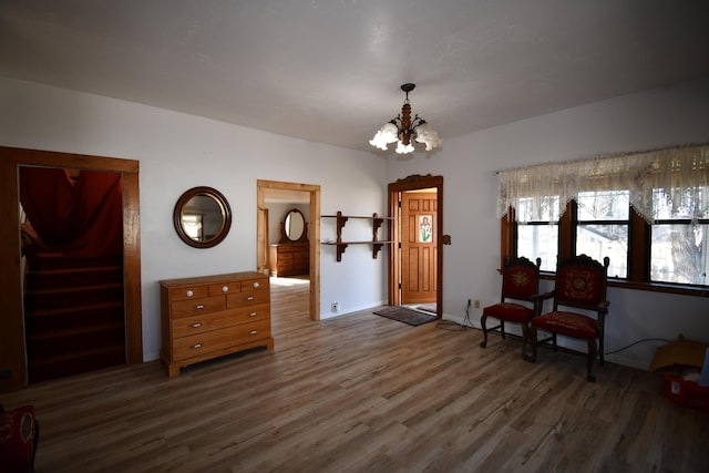 entrance foyer with baseboards, wood finished floors, and an inviting chandelier