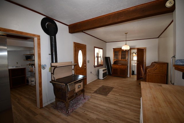 entrance foyer with beam ceiling, crown molding, and wood finished floors