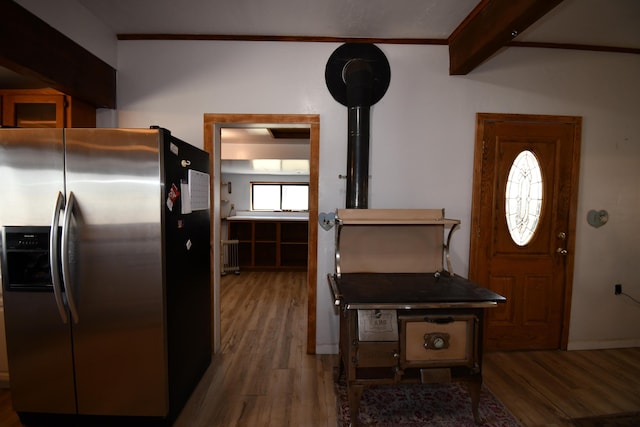 foyer entrance with wood finished floors and beamed ceiling