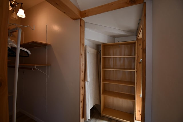 spacious closet with beamed ceiling