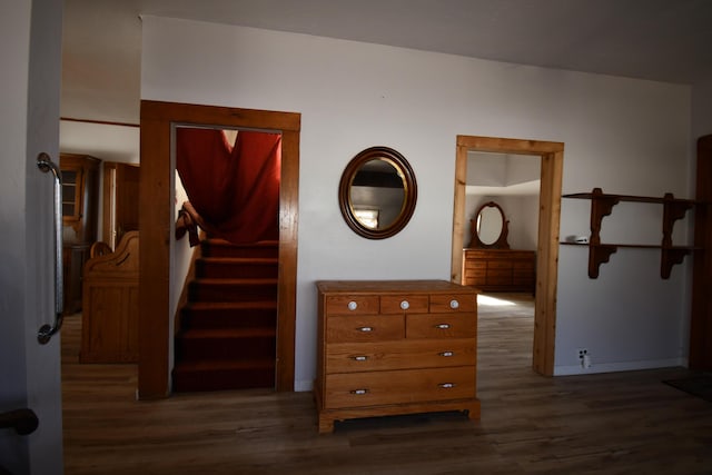 hall with dark wood-style flooring and stairs