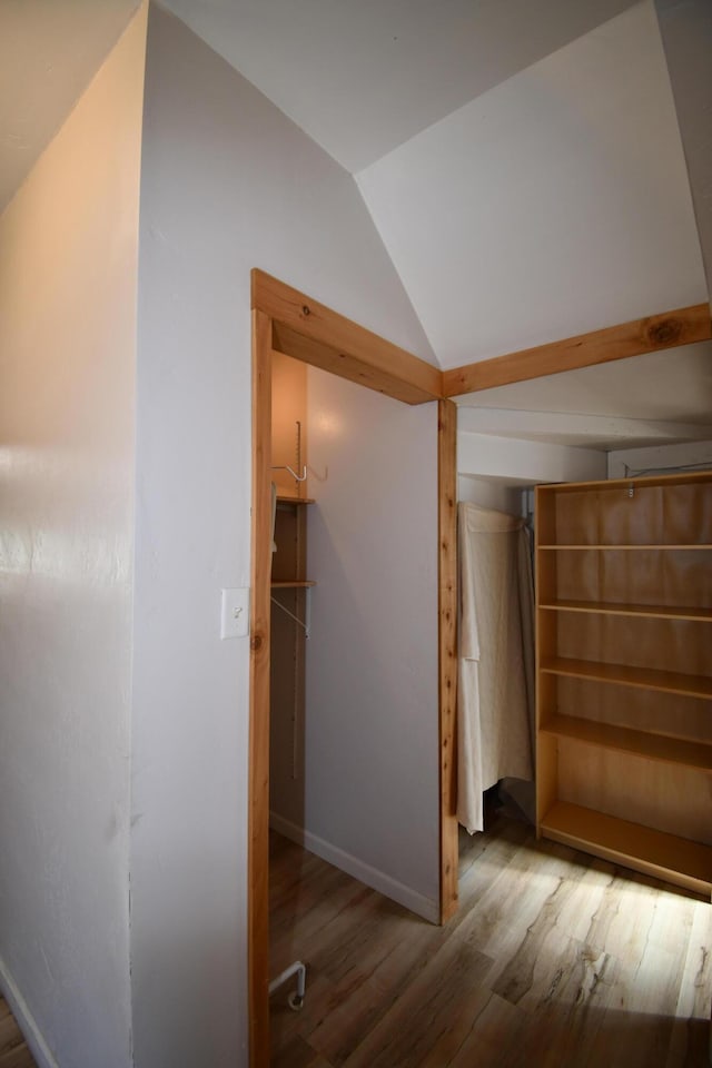 interior space featuring baseboards and wood finished floors