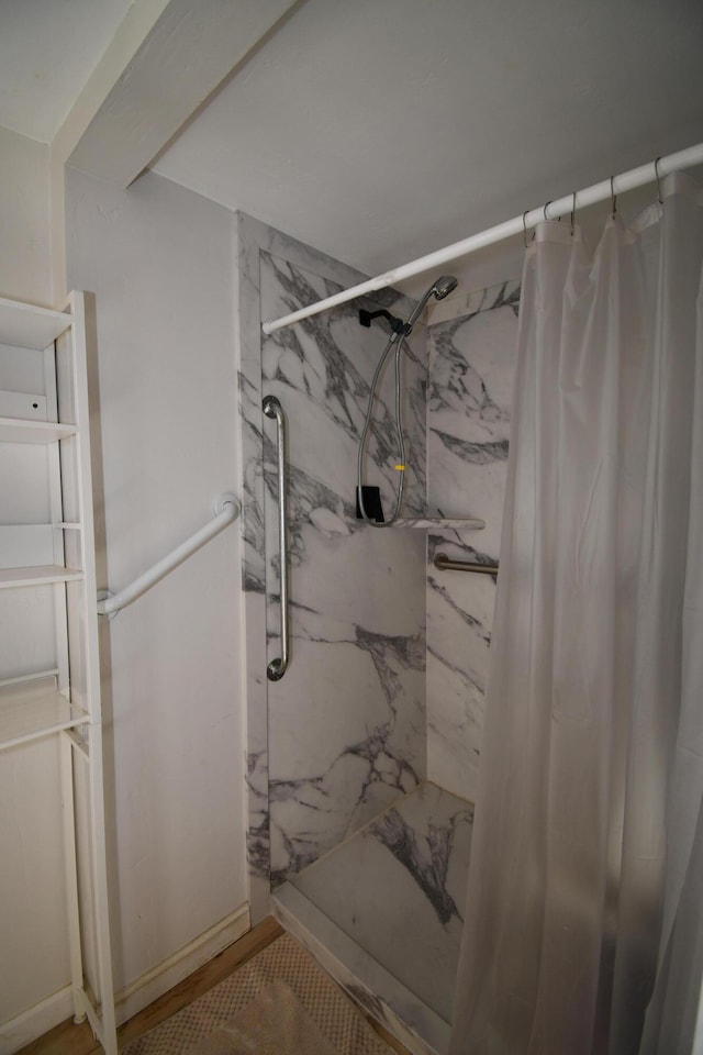 full bath with a marble finish shower