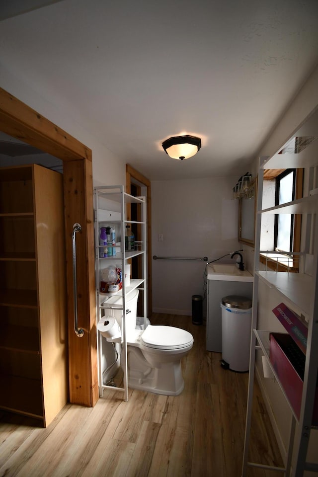 bathroom featuring toilet and wood finished floors