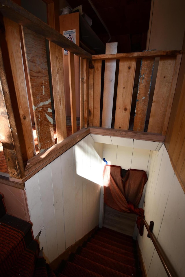 stairs featuring wooden walls