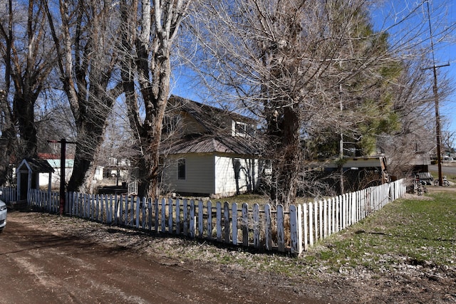 view of side of home featuring a fenced front yard