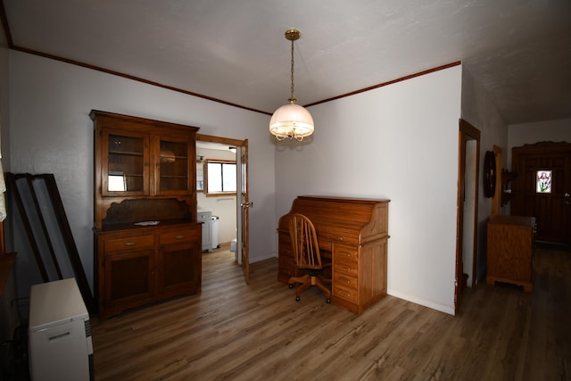 interior space featuring ornamental molding, wood finished floors, and baseboards