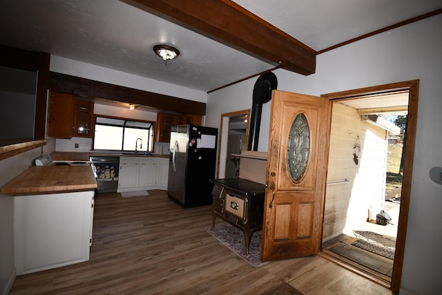 kitchen with plenty of natural light, stainless steel fridge, dishwasher, dark wood-style floors, and beam ceiling