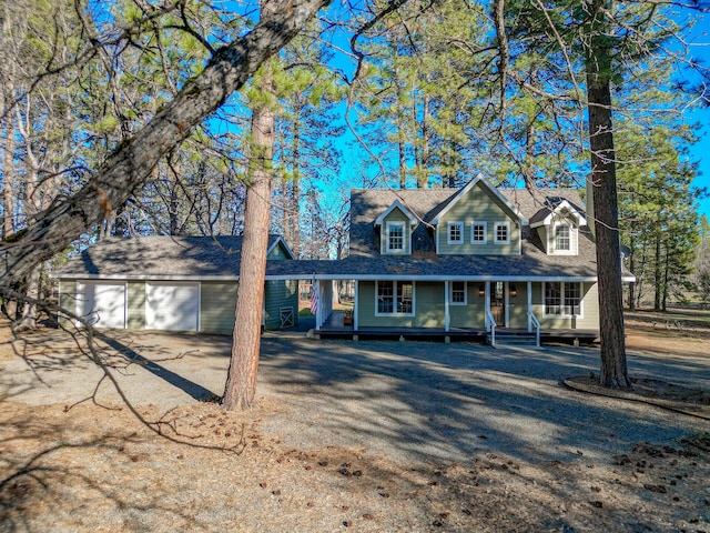 view of front facade featuring a garage, driveway, and a porch