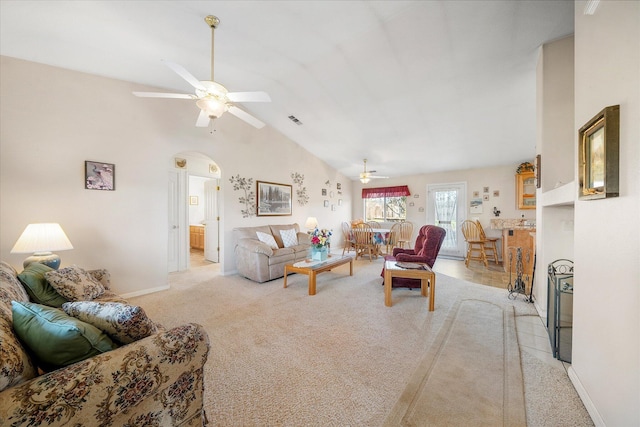 living room with ceiling fan, high vaulted ceiling, light colored carpet, visible vents, and baseboards