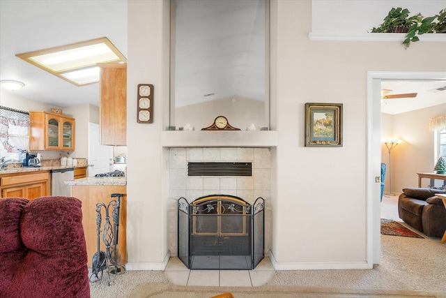 living area with lofted ceiling, baseboards, visible vents, and light colored carpet