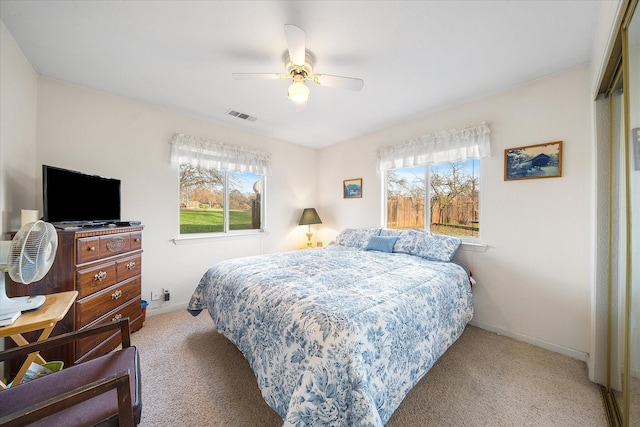 bedroom with a ceiling fan, carpet, visible vents, and baseboards