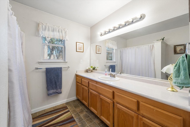 bathroom with baseboards and vanity