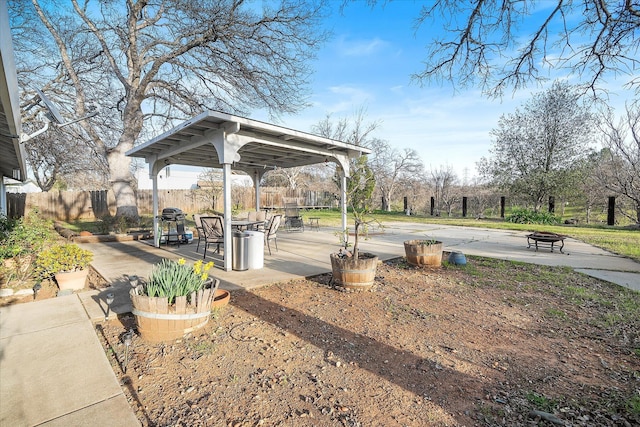 surrounding community with an outdoor fire pit, a patio area, fence, and a gazebo