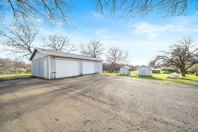 detached garage featuring a shed