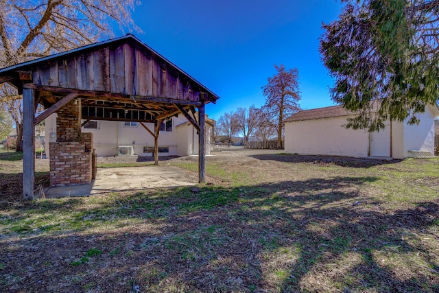 view of yard featuring an outbuilding and a patio area