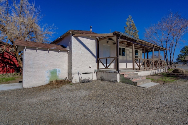 view of front of property with a porch and stucco siding