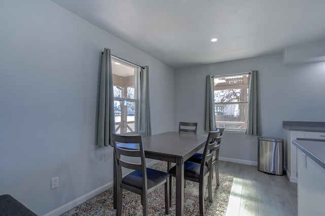 dining area featuring recessed lighting, light wood-style flooring, and baseboards