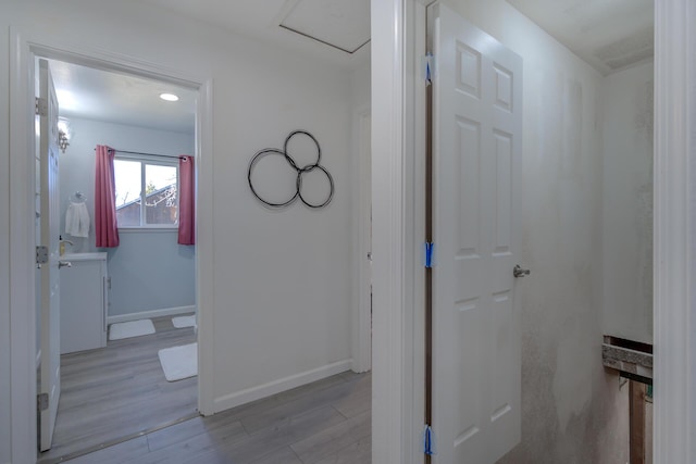 bathroom with baseboards and wood finished floors