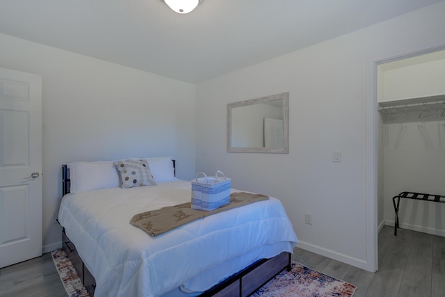 bedroom featuring baseboards and wood finished floors